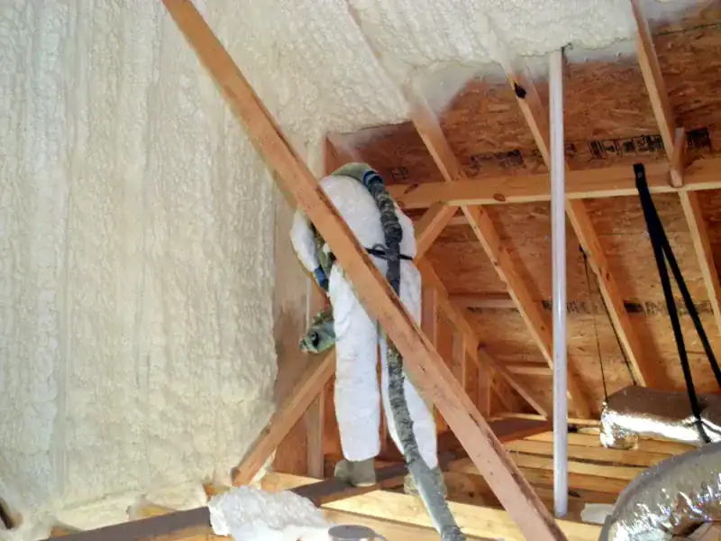 Spray foam insulation applied to attic roof deck for energy efficiency
