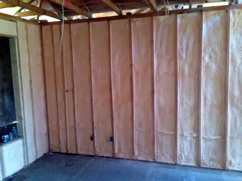 Spray foam insulation applied to interior and exterior wall cavities for air sealing and energy efficiency