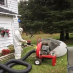 Removal vacuum machine connected to home exterior for insulation material extraction in Ontario